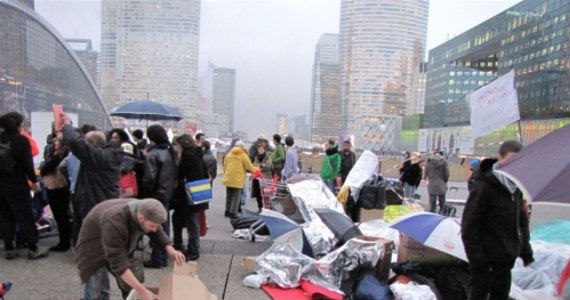 We francuskiej dzielnicy biznesu La Defense trwa wojna nerwów pomiędzy policją i "Ruchem Oburzonych". Główny plac "paryskiego Manhattanu" już piaty dzień okupują młodzi ludzie protestujący przeciwko dyktatowi światowej finansjery. Każdej nocy szturmowe oddziały policji zabierają im namioty i koce. Protestujący nie dają jednak za wygraną.