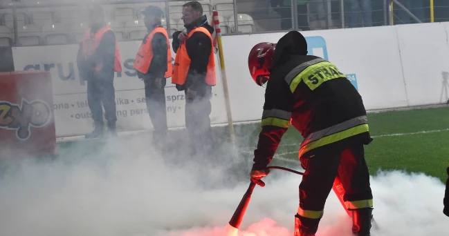 Strażak gasi race na boisku podczas meczu: Cracovia - Pogoń Szczecin