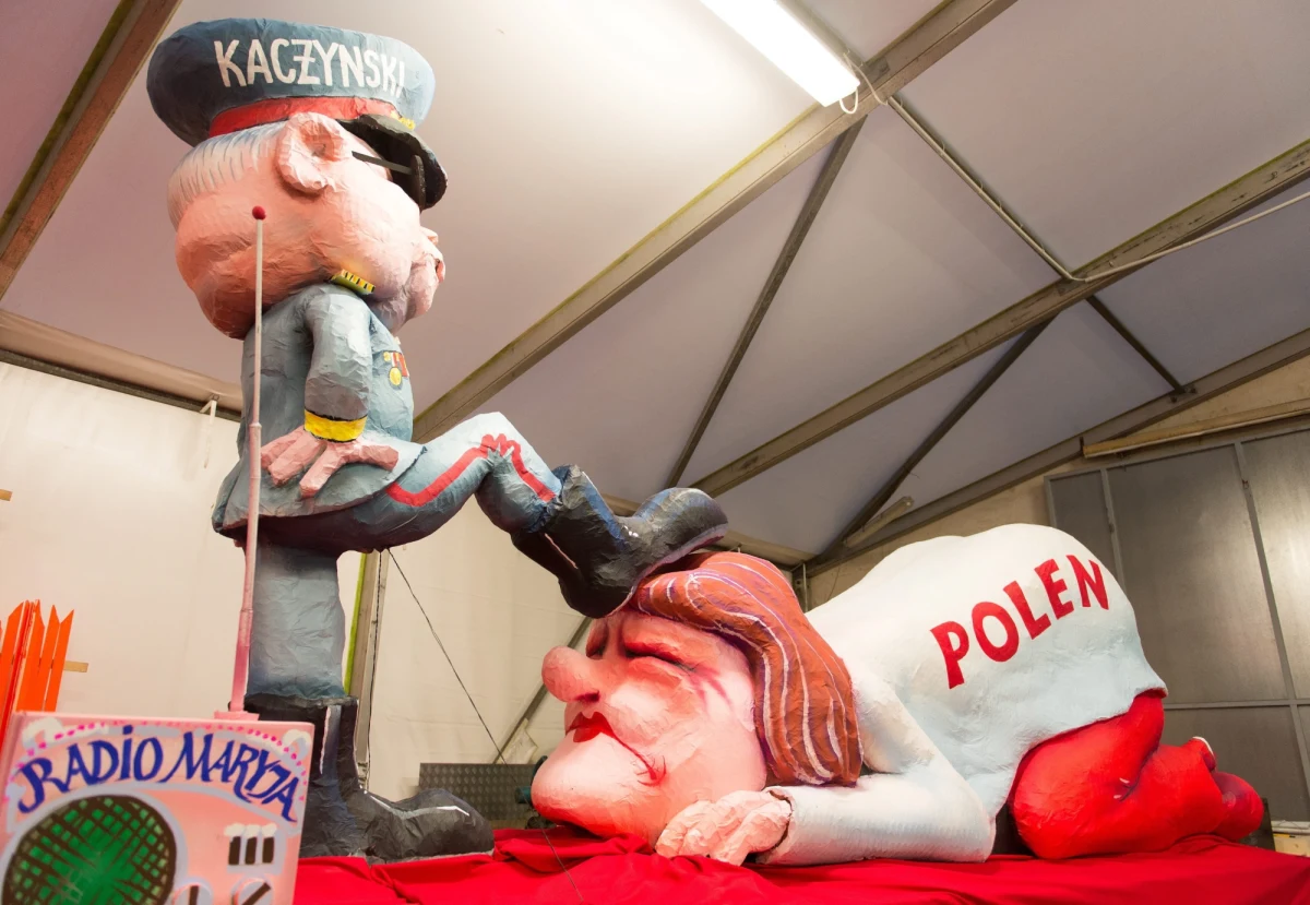 Jarosław Kaczyński w wojskowym mundurze, nogą dociska do ziemi głowę zapłakanej kobiety. Tak wygląda platforma, która miała przejechać ulicami niemieckiego Duesseldorfu w paradzie karnawałowej.Z powodu pogody paradę ostatecznie odwołano. Pomimo ostrzeżeń przed wichurą w Kolonii odbył się tradycyjny pochód. Tam motywem przewodnim parady była w tym roku krytyka polityki migracyjnej kanclerz Angeli Merkel. 