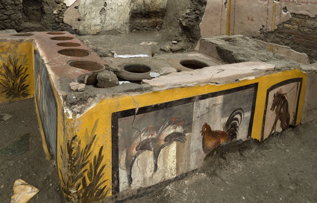 Stragan, na którym sprzedawano uliczne jedzenie, został odnaleziony podczas wykopalisk na terenie starożytnych Pompejów. Zdjęcia prezentujące to niezwykłe odkrycie zostały opublikowane w sobotę. Największe wrażenie robią odsłonięte dobrze zachowane freski.