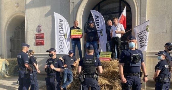 Bele siana, rozlana gnojówka i odpalone race - tak wyglądał protest AGROunii przed gmachem resortu rolnictwa w Warszawie. Jego uczestnicy zamocowali na drzwiach gmachu łańcuchy i kłódki, którym towarzyszyły tabliczki z napisem: "Afrykański Pomór Świń. Zakaz wstępu". "Nie ma przyzwolenia na to, żeby ministerstwo, które nie działa, mogło być otwarte" - tłumaczył lider AGROunii Michał Kołodziejczak. "Oni zamknęli się na nas. Dzisiaj my ich zamykamy w tym gmachu" - dodał. 