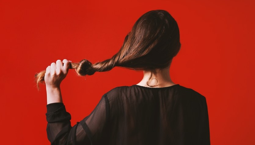 Long hair pulling. Rear view of a Lady with long hair..