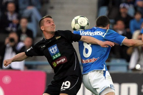 Robert Lewandowski (z prawej) walczy o piłkę z Marcinem Kaczmarkiem