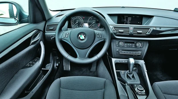 Na desce rozdzielczej BMW X1 dominują proste linie, kierownica świetnie leży w rękach.