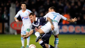 Ludovic Obraniak (w środku) kontra Benoit Cheyrou z Marsylii