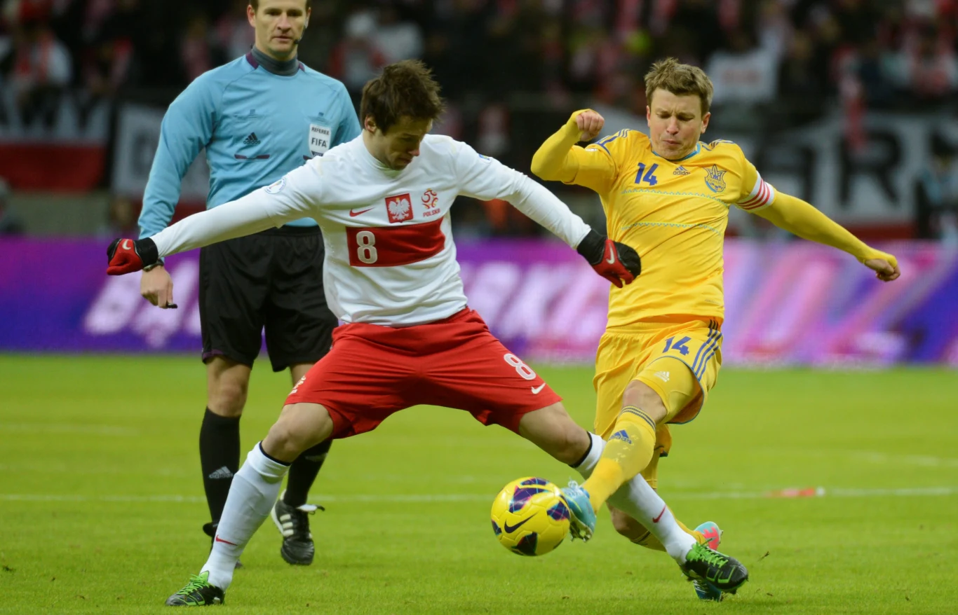 Ukrainiec Rusłan Rotań (P) walczy o piłkę z Polakiem Grzegorzem Krychowiakiem