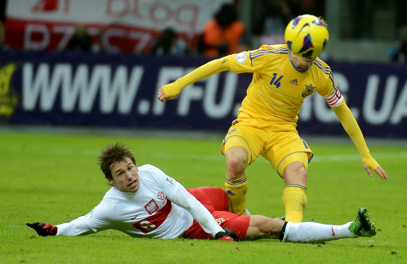 Ukrainiec Rusłan Rotan (P) walczy o piłkę z Polakiem Grzegorzem Krychowiakiem 