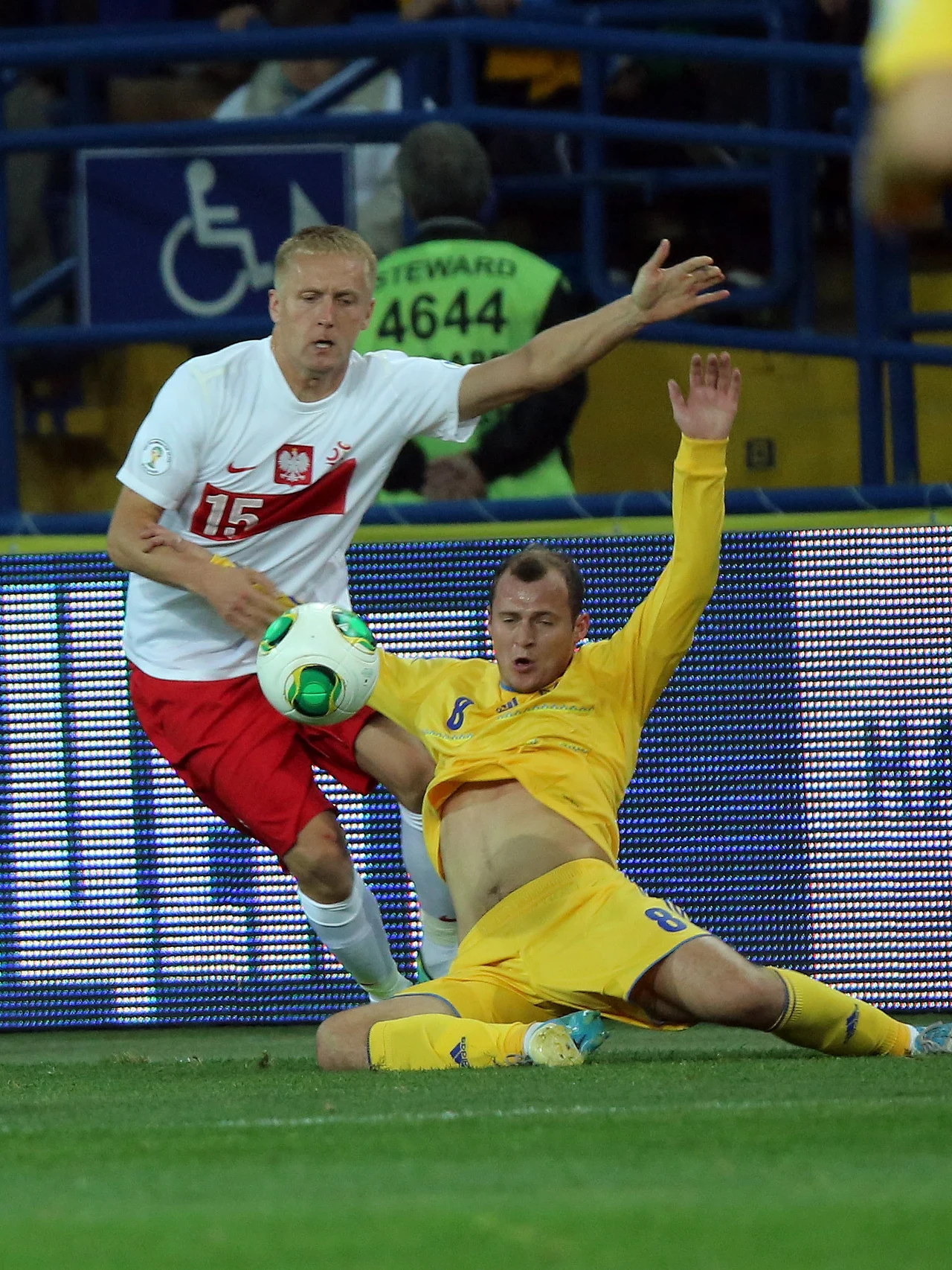 W starciu o piłkę reprezentacji Polski Kamil Glik (L) i Ukrainiec Roman Zozulia