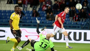 Piłkarz Wisły Kraków Paweł Brożek (P) pokonuje bramkarza Widzewa Łódź Macieja Mielcarza 