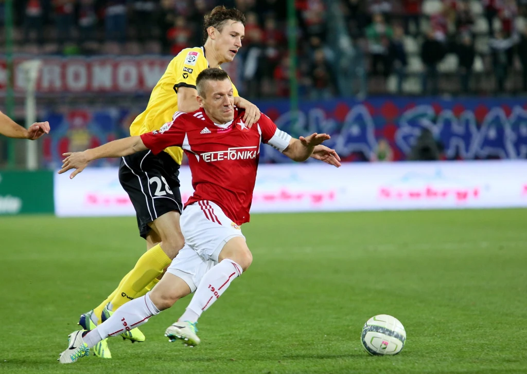 Zawodnik Widzewa Łódź Povilas Leimonas (L) walczy o piłkę z Łukaszem Gargułą 