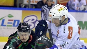 Hokeista Aksam Unii Oświęcim Mateusz Bepierszcz (P) walczy o krążek z Janem Steberem (L) z GKS Tychy