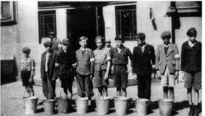 Chłopcy z powstańczymi opaskami na rekach