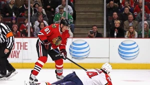 Marian Hossa #81 z Chicago Blackhawks próbuje wydobyć krążek spod Erika Gudbranso.