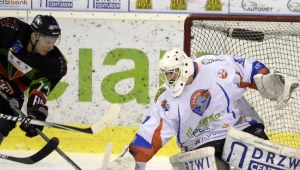 Hokeista GKS Tychy Josef Vitek (L) w ataku na bramkę Bryana Pittona (P) z Ciarko PBS Bank Sanok