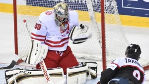 Przemysław Odrobny (z lewej), bramkarz reprezentacji Polski łapie krążek po strzale Seijiego Takahashiego z Japonii 