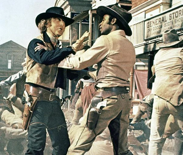 W 1974 roku powrócił do współpracy z Brooksem w filmie "Płonące siodła" - parodii gatunku kinowego westernu, wyśmiewającą przy okazji stworzony przez Hollywood mit Dzikiego Zachodu. Głównym bohaterem filmu był bowiem czarnoskóry szeryf, sprawujący rządy ku niezadowoleniu białej populacji miasteczka. W 1974 roku powrócił do współpracy z Brooksem w filmie "Płonące siodła" - parodii gatunku kinowego westernu, wyśmiewającą przy okazji stworzony przez Hollywood mit Dzikiego Zachodu. Głównym bohaterem filmu był bowiem czarnoskóry szeryf, sprawujący rządy ku niezadowoleniu białej populacji miasteczka.