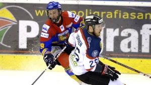 Hokeista Ciarko PBS Bank STS Sanok Joni Tuominen (P) walczy o krążek z Dariuszem Gruszką (L) z TatrySki Podhale Nowy Targ