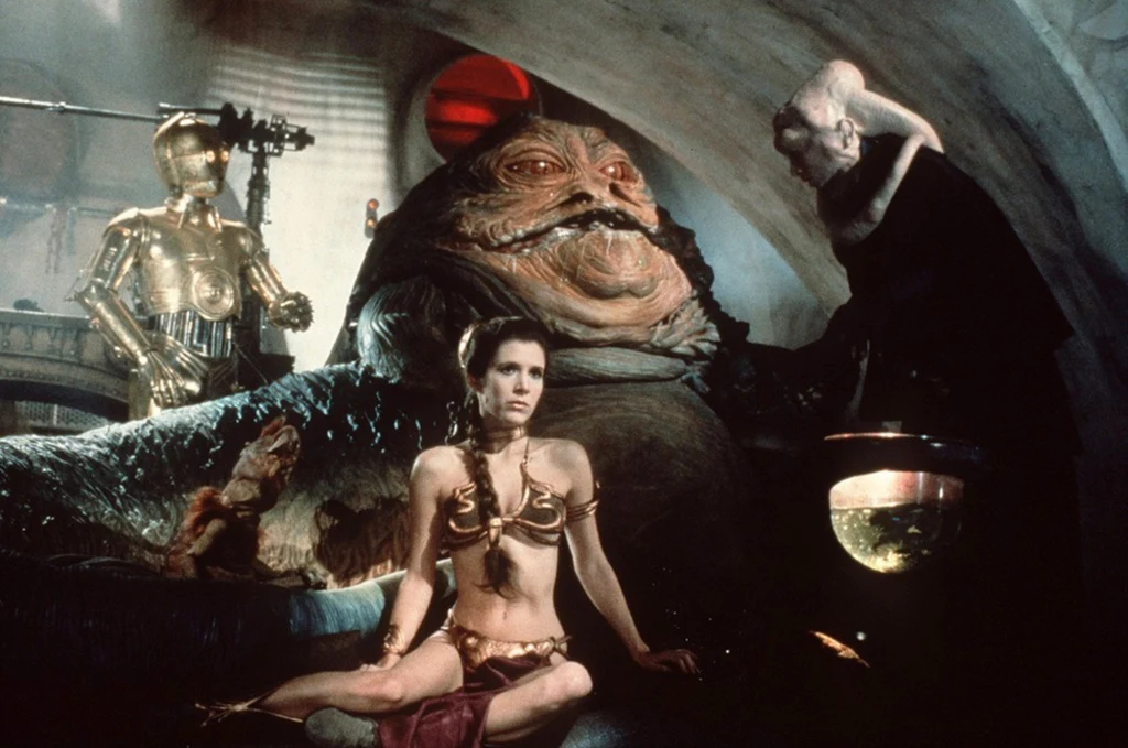 Carrie Fisher w złotym bikini w "Powrocie Jedi" Carrie Fisher w złotym bikini w "Powrocie Jedi"