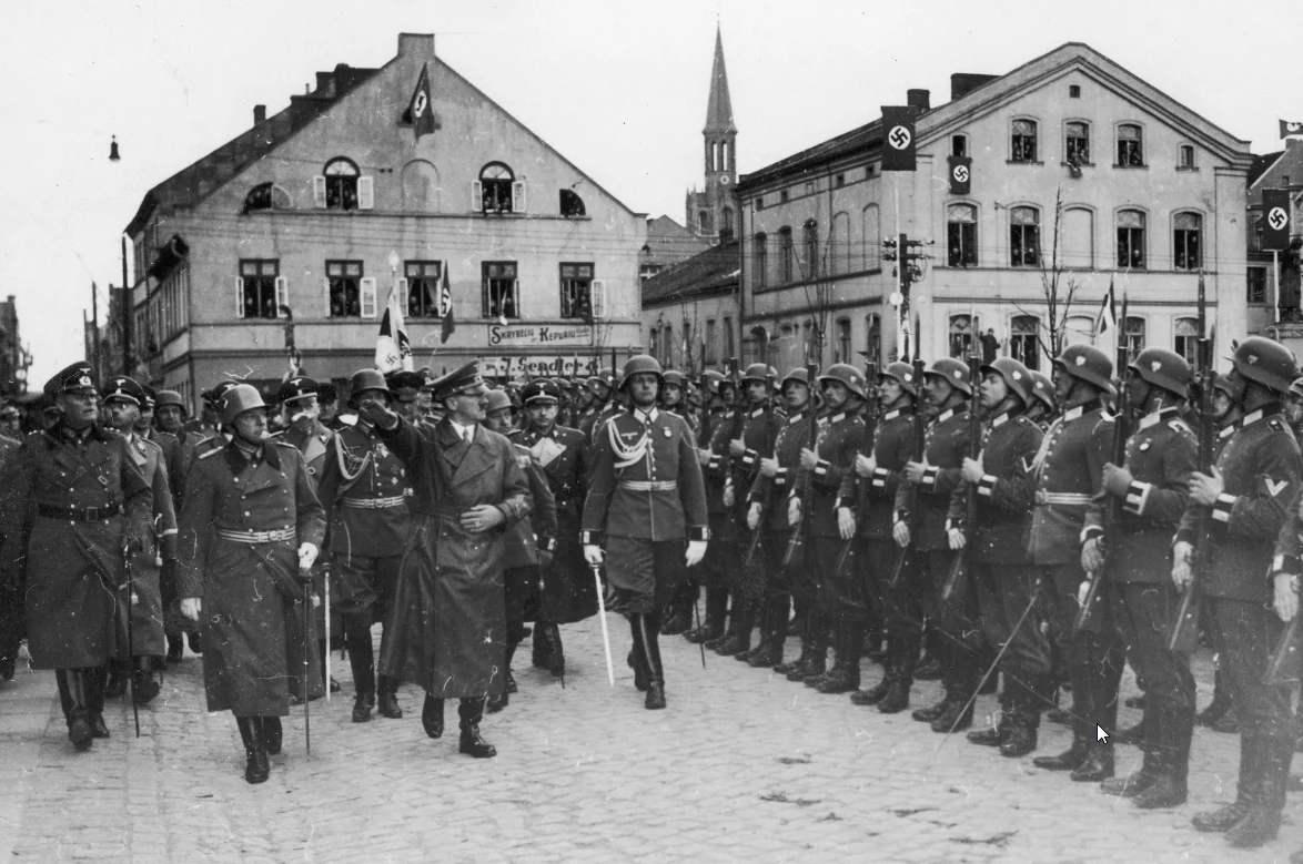 Adolf Hitler z współpracownikami na Placu Teatralnym w Kłajpedzie. Obok idą Wilhelm Keitel (1. z lewej) i Heinrich Himmler (za Keitlem)