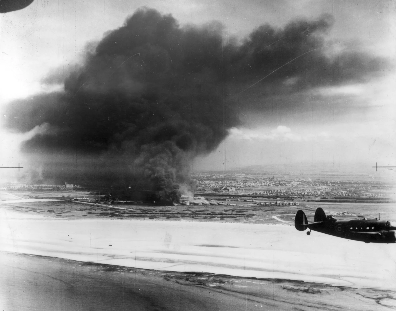 Samoloty lockheed hudson brytyjskiego Dowództwa Obrony Wybrzeża przelatują ponad płonącymi zbiornikami z paliwem pod Dunkierką /Keystone/Getty Images