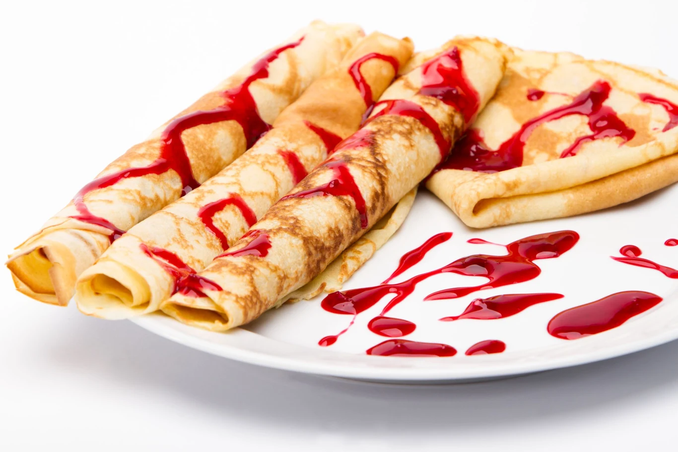 Naleśniki budyniowe można podawać na słodko m.in. z sosem wiśniowym. 