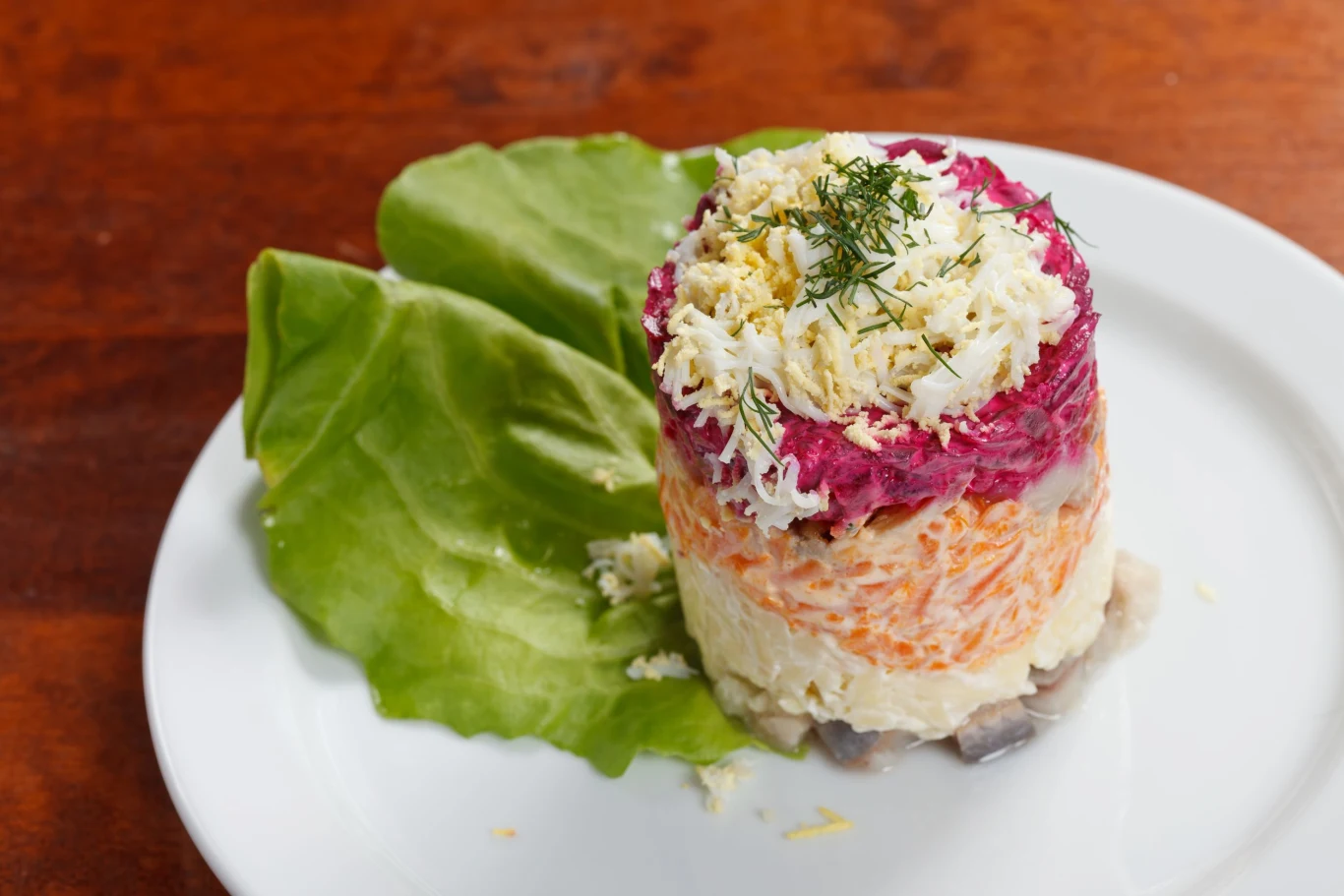 Sałatkę śledziową można przygotowywać warstwami w mniejszych porcjach, co idealnie sprawdzi się jako efektowny poczęstunek dla gości 