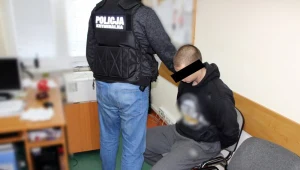 Policjant z zatrzymanym mężczyzną 