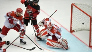 Duński bramkarz Sebastian Dahm przepuszcza krążek do siatki podczas meczu z Kanadą 