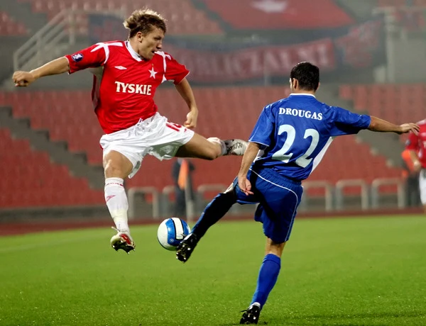 Jakub Błaszczykowski w starciu Wisły z Iraklisem Saloniki (z prawej Panagiotis Drougas) w Pucharze UEFA, we wrześniu 2006 r. Jakub Błaszczykowski w starciu Wisły z Iraklisem Saloniki (z prawej Panagiotis Drougas) w Pucharze UEFA, we wrześniu 2006 r.