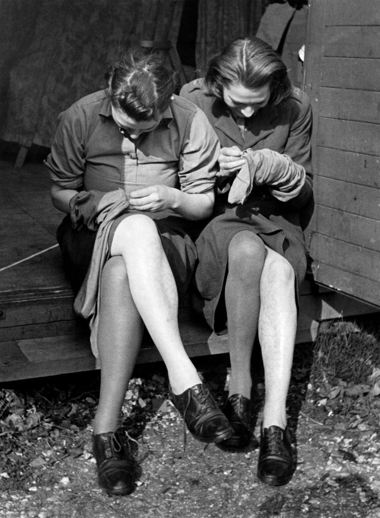 W parkach, podczas spotkań z koleżanką, ta forma spędzania wolnego czasu była powszechna w latach czterdziestych ubiegłego wieku. Fot. Getty/ Reparacja pończoch 1941