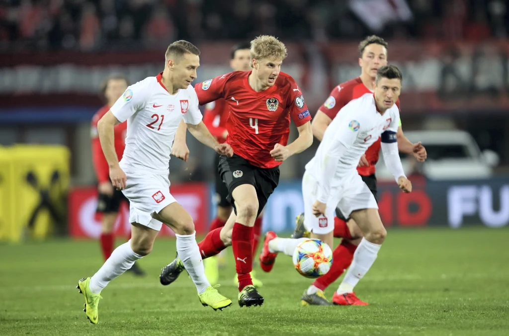 Przemysław Frankowski (L) i Robert Lewandowski (P) oraz Martin Hinteregger (2L) i Julian Baumgartlinger (2P) z Austrii 