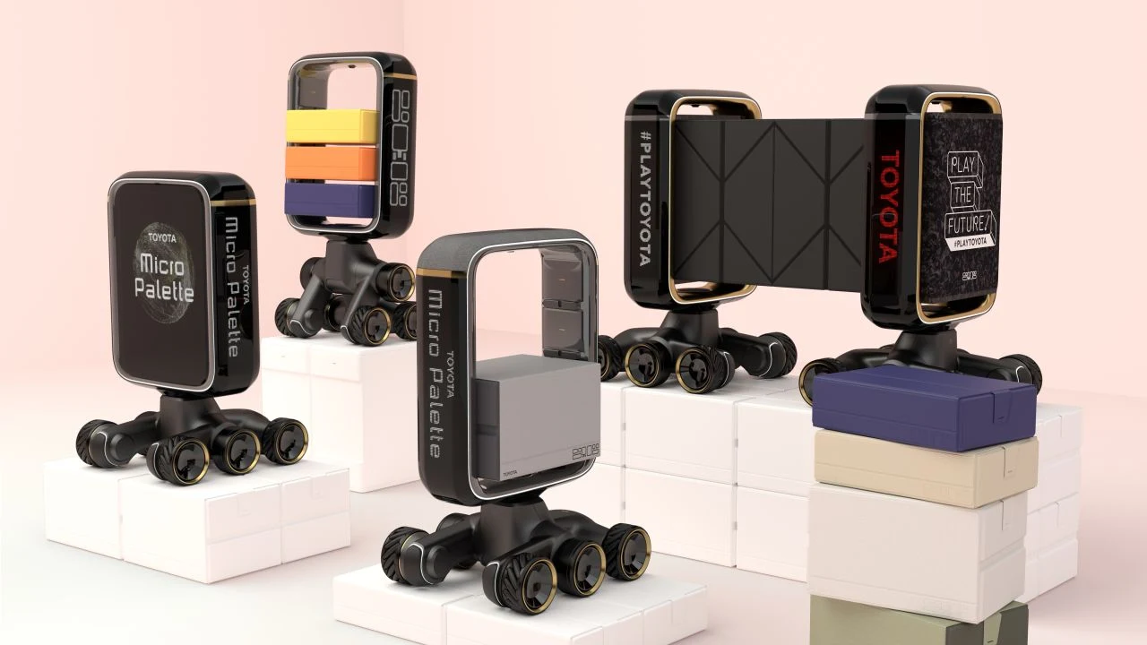Nie mniej ciekawy jest mały robot Toyota Micro Palette, służący do dostarczania małych przedmiotów, takich jak butelki wody. Nie mniej ciekawy jest mały robot Toyota Micro Palette, służący do dostarczania małych przedmiotów, takich jak butelki wody.