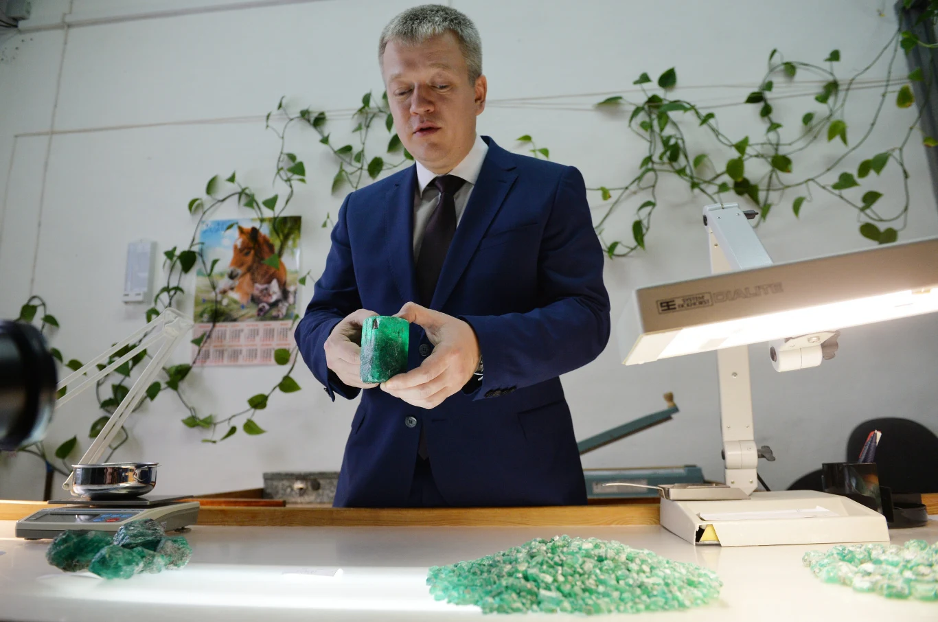 Pracownik Maliszewskoje prezentuje mediom kamień.