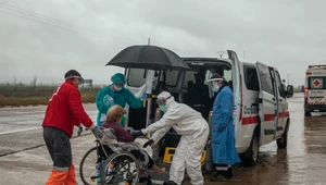Pracownicy Czerwonego Krzyża przewożą pacjentkę zakażoną koronawirusem, Hiszpania, Huesca, 1 kwietnia 2020