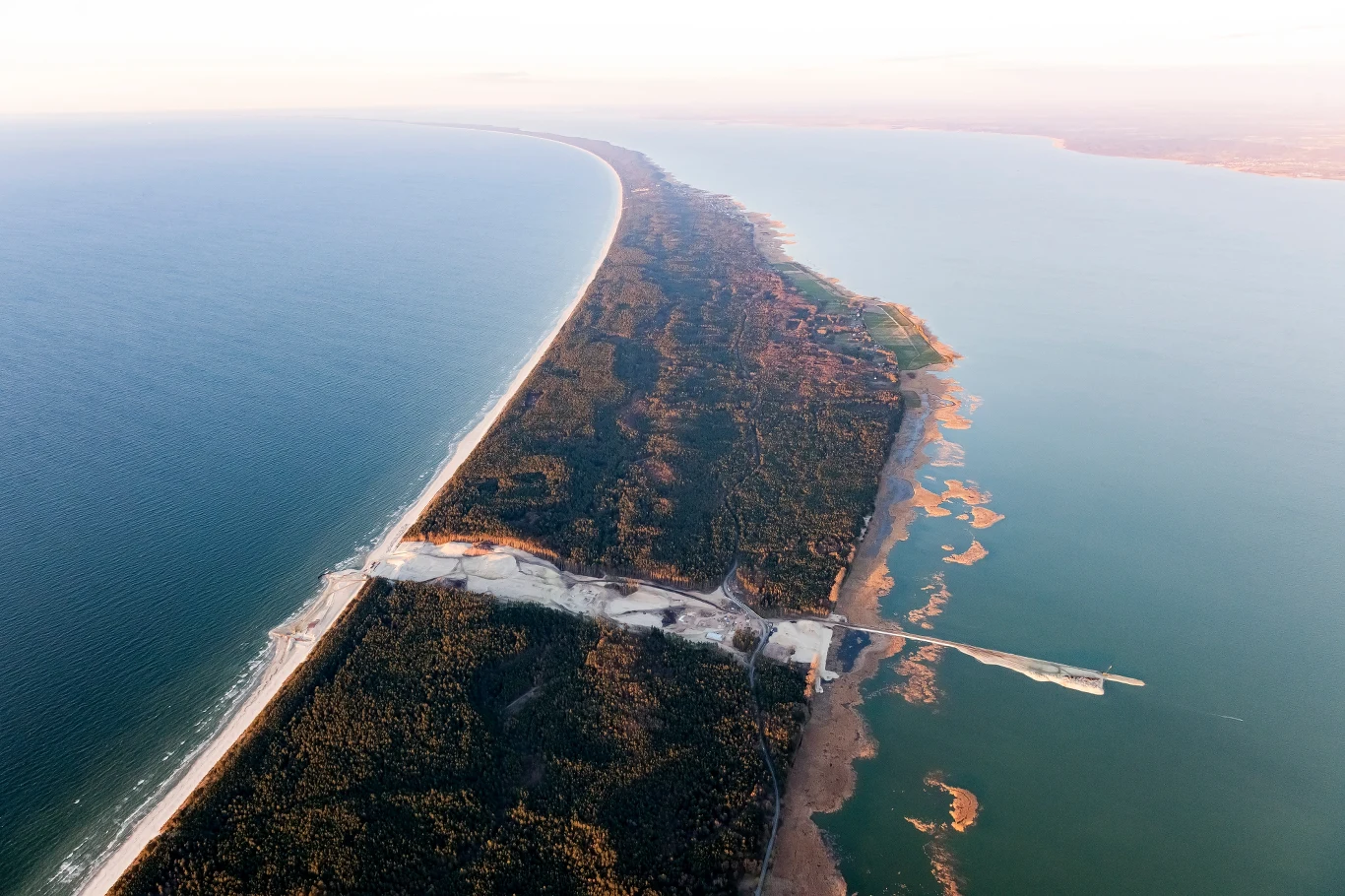 "Rozpoczynamy roboty kafarowe przy falochronie zachodnim. Pogłębiamy też basen wodny. W tym trudnym czasie staramy się, przede wszystkim dbając o bezpieczeństwo naszych pracowników i podwykonawców, zapewnić im wszystkie możliwe środki ochrony i kontynuować zaplanowane roboty. Mamy środki dezynfekujące, środki ochrony osobistej. Pracujemy w dwóch zespołach, zmianowo, tydzień na tydzień"- zaznaczył dyrektor projektu z konsorcjum NDI/Besix Jacek Szymański. Dodał, że na budowie pracuje aktualnie około 150 osób, 40 jednostek sprzętowych. "Zatrudniamy około 30 firm podwykonawczych, a zdecydowana większość pochodzi z regionu"- podkreślił.