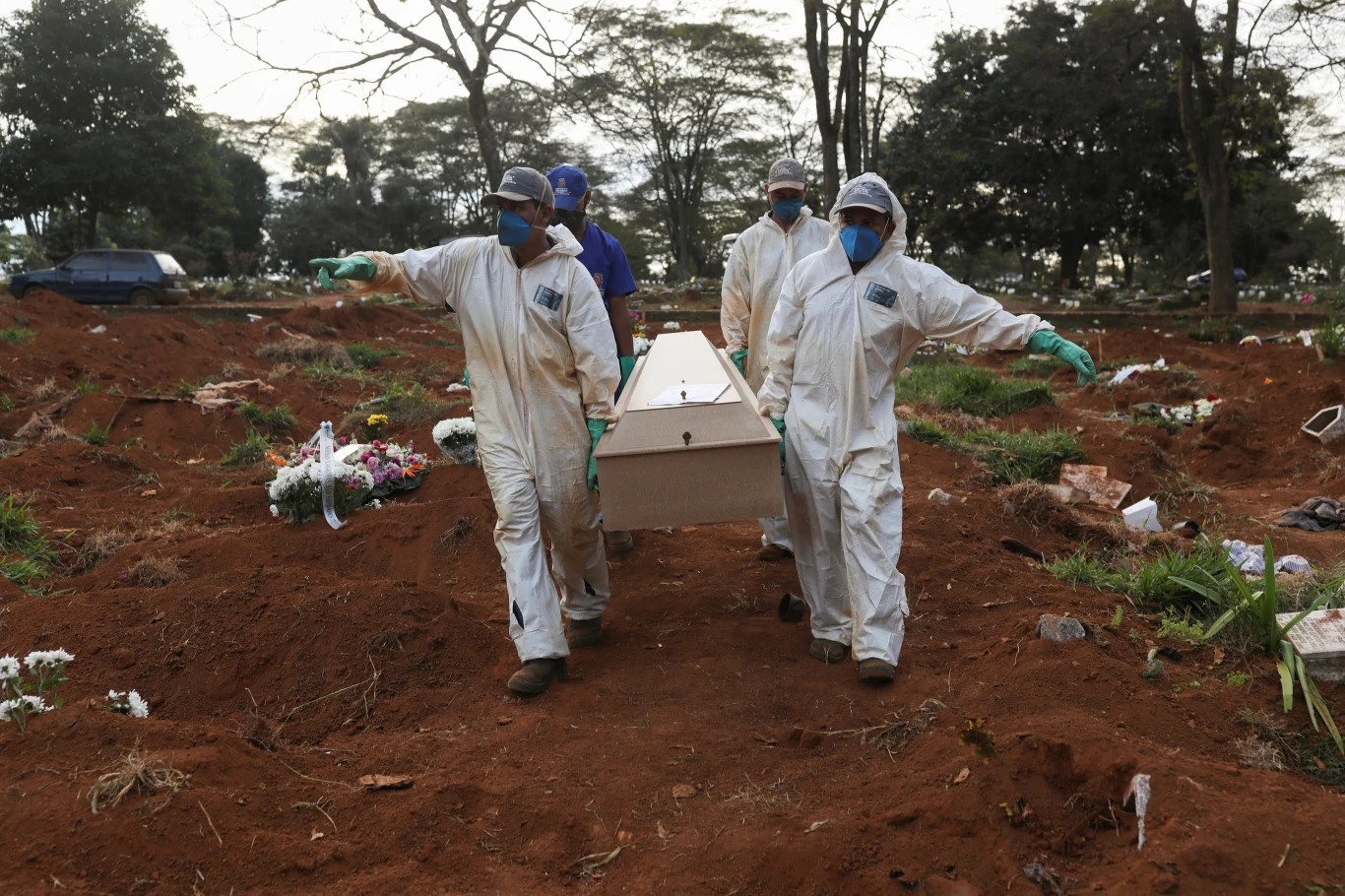 Grabarze w strojach ochronnych na największym cmentarzu w Sao Paulo - Vila Formosa.