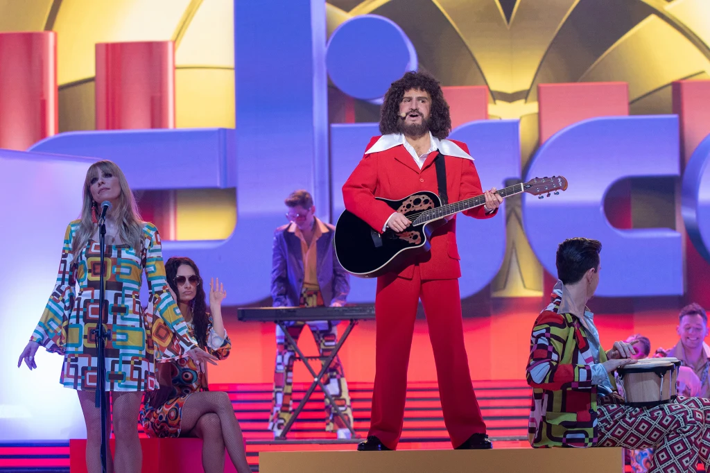 Natalia Avelon jako George Baker Natalia Avelon jako George Baker