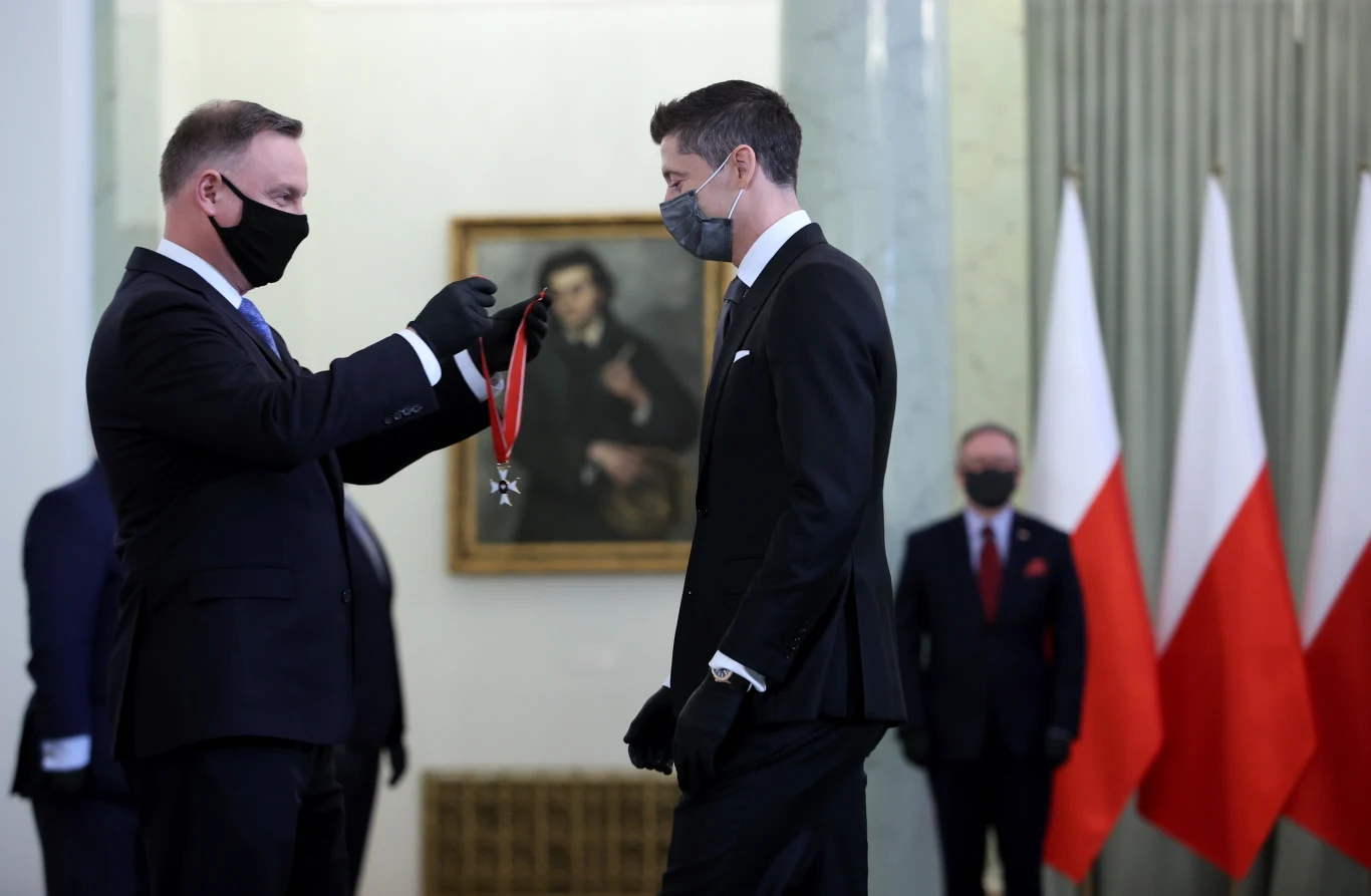 Prezydent Andrzej Duda wręcza wyróżnienie Robertowi Lewandowskiemu.