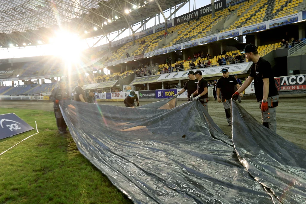 Stadion Apatora. Służby niosą kawałek materiału, który ma chronić tor przed deszczem Stadion Apatora. Służby niosą kawałek materiału, który ma chronić tor przed deszczem