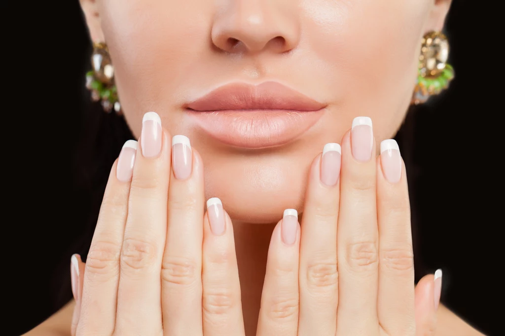 Manicure francuski. W latach 90. modne były grube białe linie. Teraz styliści proponują  delikatne odcięcia wykonane z użyciem stempla