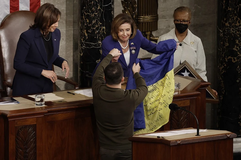 Wołodymyr Zełenski wręcza Nancy Pelosi flagę Ukrainy