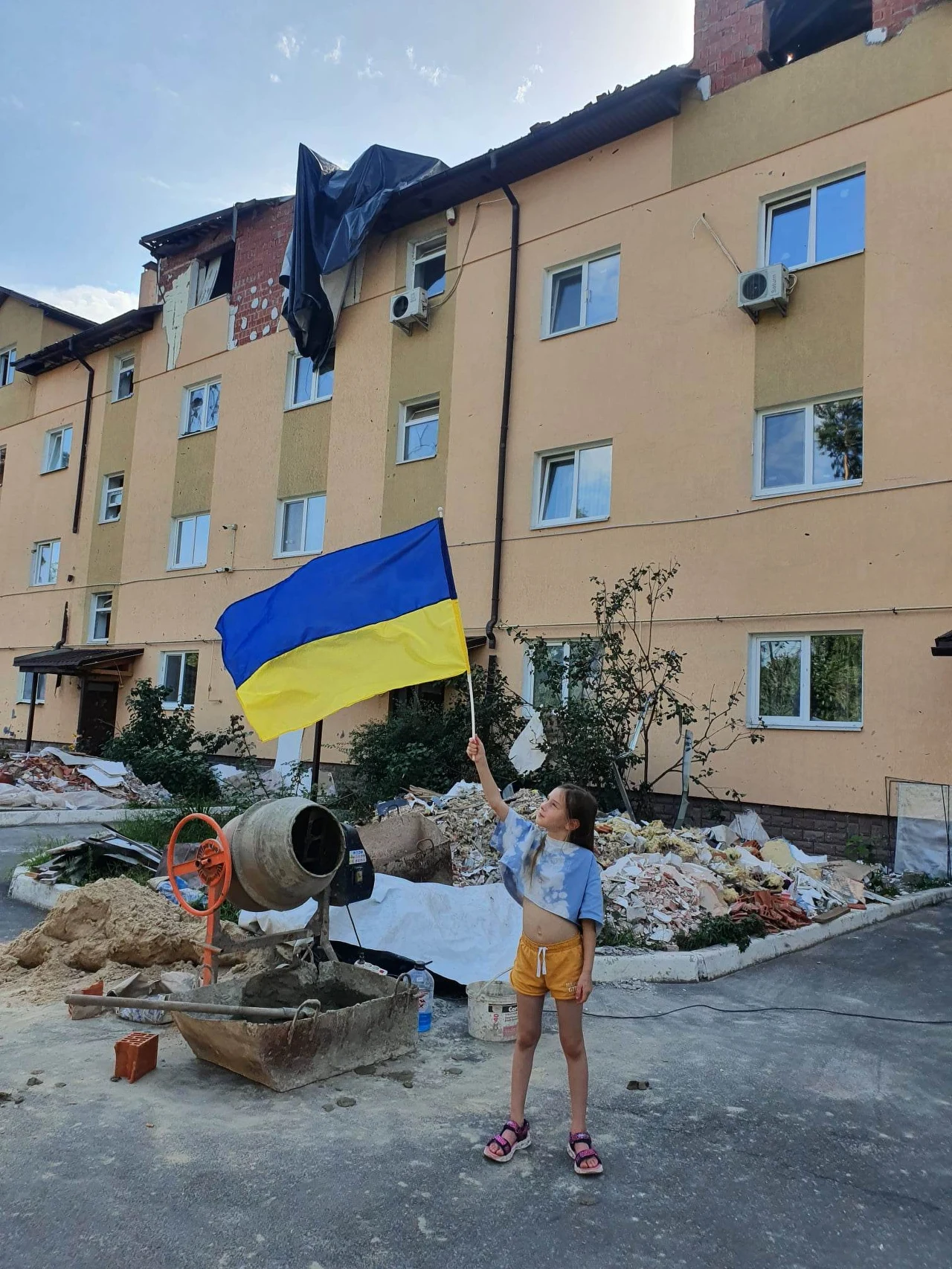 Córka Anny przed zniszczonym blokiem w Irpieniu Córka Anny przed zniszczonym blokiem w Irpieniu