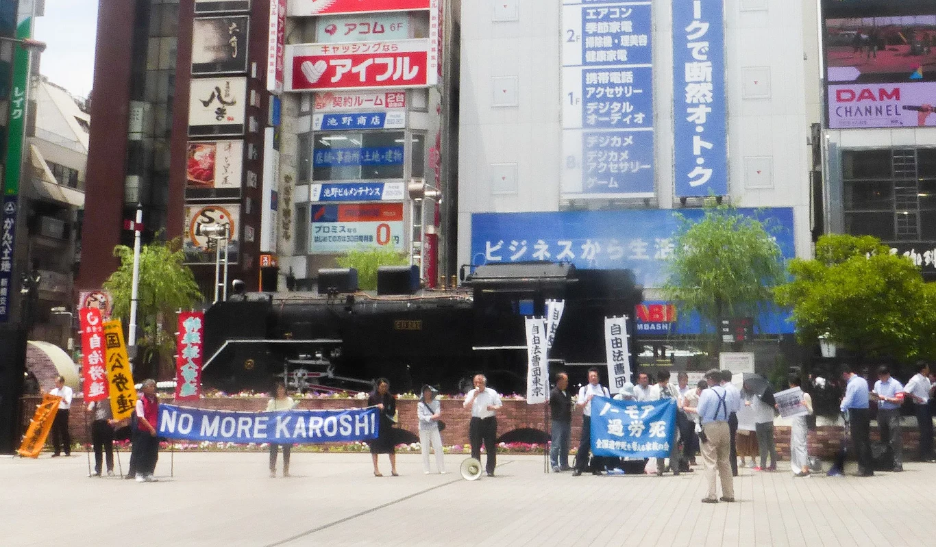 "No more karoshi" - protest w tokijskiej dzielnicy Shinbashi, czerwiec 2018 r. / źródło: Wikipedia, Nesnad "No more karoshi" - protest w tokijskiej dzielnicy Shinbashi, czerwiec 2018 r. / źródło: Wikipedia, Nesnad