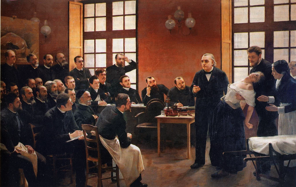 Francuski neurolog Jean-Martin Charcot podczas wykładu prezentuje pacjentkę z napadem histerii. Obraz: Une leçon clinique à la Salpêtrière, 1887 r.