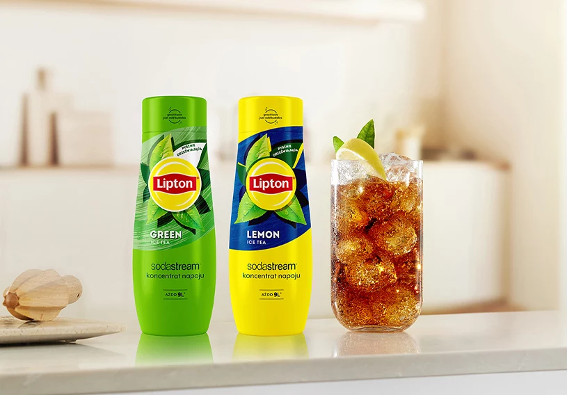 Syropy Lipton z szklanką na kuchennym blacie