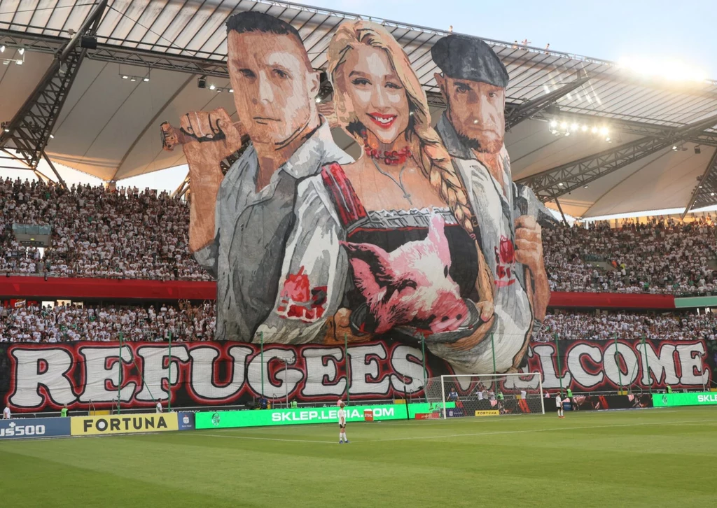 "Witajcie, uchodźcy". Oprawa na meczu Legia Warszawa - Zagłębie Lubin, 20.07.2024 r. "Witajcie, uchodźcy". Oprawa na meczu Legia Warszawa - Zagłębie Lubin, 20.07.2024 r.
