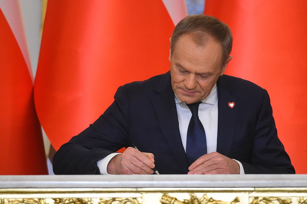 Premier Donald Tusk składa podpis (zdj. arch.)