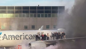 Pasażerowie stojący na skrzydle samolotu American Airlines, ewakuowani po tym, jak maszyna się zapaliła