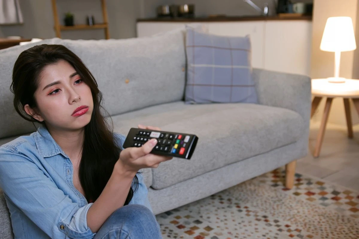 Kobieta z pilotem od telewizora w ręce