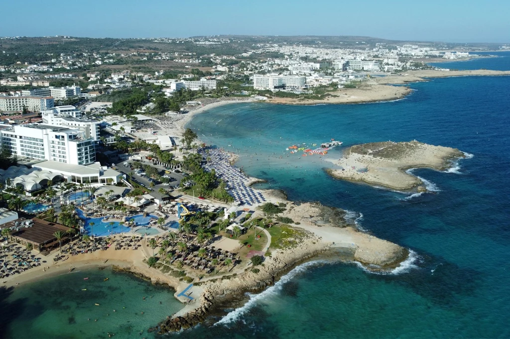 This aerial view shows beachgoers at Nissi Beach in Cyprus' southern coastal resort town of Ayia Napa on August 1, 2023. (Photo by Etienne TORBEY / AFP) This aerial view shows beachgoers at Nissi Beach in Cyprus' southern coastal resort town of Ayia Napa on August 1, 2023. (Photo by Etienne TORBEY / AFP)